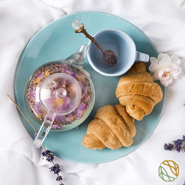 a breakfast containing chamomile and lavender tea with two croissants on the side. the MaChii Tea logo is on the right side. 